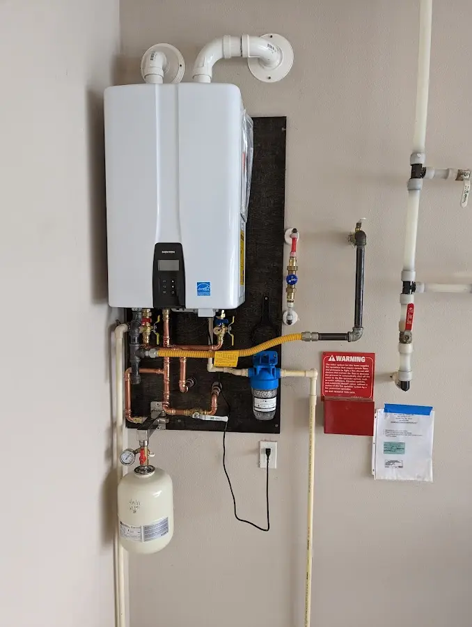 Professional plumber installing copper piping in a Dumfries home